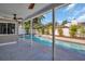 Covered patio with ceiling fan overlooks a sparkling pool and lush backyard at 3202 Cullendale Dr, Tampa, FL 33618