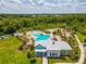Aerial view of the neighborhood splash pad and pool in relation to the recreation center and playground at 33716 Elm Hill Br, Wesley Chapel, FL 33545