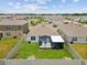 Aerial view of backyard featuring fenced yard with screened patio in a residential neighborhood at 33716 Elm Hill Br, Wesley Chapel, FL 33545