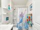 Charming bathroom with nautical-themed decor and a mermaid shower curtain at 33716 Elm Hill Br, Wesley Chapel, FL 33545