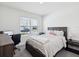 Cozy bedroom featuring a comfortable bed, natural light and a desk area at 33716 Elm Hill Br, Wesley Chapel, FL 33545