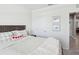 Relaxing bedroom with a soft, inviting bed and light neutral decor and a view to the hall at 33716 Elm Hill Br, Wesley Chapel, FL 33545