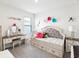 Adorable bedroom featuring a trundle bed, vanity and pops of color at 33716 Elm Hill Br, Wesley Chapel, FL 33545