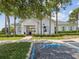 Community clubhouse with white siding, light blue shutters, and a well-manicured lawn at 33716 Elm Hill Br, Wesley Chapel, FL 33545