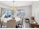 Bright dining area with sliding glass doors and modern chandelier at 33716 Elm Hill Br, Wesley Chapel, FL 33545
