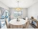 Bright dining area with stylish chandelier and sliding glass doors at 33716 Elm Hill Br, Wesley Chapel, FL 33545