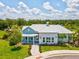 Exterior of the community recreation center with pavers, mature landscaping, and a metal roof at 33716 Elm Hill Br, Wesley Chapel, FL 33545