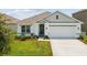 Charming single-story home with a well-manicured lawn and a two-car garage at 33716 Elm Hill Br, Wesley Chapel, FL 33545