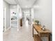 Inviting hallway with neutral paint and tile flooring, leading to bedrooms and dining area at 33716 Elm Hill Br, Wesley Chapel, FL 33545