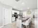 Open kitchen features granite counters, stainless appliances, island with seating, and ample cabinet space at 33716 Elm Hill Br, Wesley Chapel, FL 33545