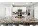 Modern kitchen island with granite countertops, stainless steel appliances, and bar stool seating at 33716 Elm Hill Br, Wesley Chapel, FL 33545