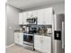 Well-lit kitchen with white cabinetry, stainless steel appliances, and granite countertops at 33716 Elm Hill Br, Wesley Chapel, FL 33545