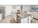 Open-concept kitchen featuring a large island with granite countertops and stainless steel appliances at 33716 Elm Hill Br, Wesley Chapel, FL 33545