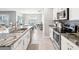 Bright kitchen featuring stainless steel appliances, granite countertops, and an island with a sink at 33716 Elm Hill Br, Wesley Chapel, FL 33545