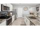 Well-equipped kitchen offers stainless appliances, granite counters, and large kitchen island with sink at 33716 Elm Hill Br, Wesley Chapel, FL 33545