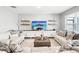Comfortable living room with modern decor, plush seating, and a large entertainment center at 33716 Elm Hill Br, Wesley Chapel, FL 33545