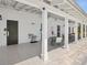 Outdoor patio area with tables, seating, and access to restrooms in the community recreation center at 33716 Elm Hill Br, Wesley Chapel, FL 33545