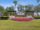 Community entrance sign for Avalon Park featuring colorful landscaping and brick architectural details at 33716 Elm Hill Br, Wesley Chapel, FL 33545