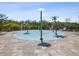 A splash pad is surrounded by a fence and landscaping at 33716 Elm Hill Br, Wesley Chapel, FL 33545