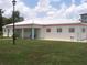 Community clubhouse with a white metal roof, light beige stucco walls and pastel accent columns at 33821 Terrace Blvd, Wesley Chapel, FL 33543