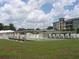 Community recreation area features a covered shuffleboard court with seating, set against a backdrop of residential buildings at 33821 Terrace Blvd, Wesley Chapel, FL 33543