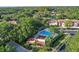 Aerial view of a community pool surrounded by trees, landscaping, and residential buildings at 3476 Tarpon Woods Blvd, Palm Harbor, FL 34685