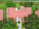An aerial view of the community highlighting tile roofs, landscaped grounds and nearby parking at 3476 Tarpon Woods Blvd, Palm Harbor, FL 34685