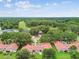 Panoramic aerial shot showcasing the community's lush green surroundings, tile roofs and proximity to a golf course at 3476 Tarpon Woods Blvd, Palm Harbor, FL 34685