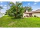 Lush backyard featuring a brick paver patio, tropical landscaping, and a tranquil setting for outdoor living at 3476 Tarpon Woods Blvd, Palm Harbor, FL 34685