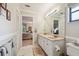 Bathroom featuring double sinks, tiled floors, and access to the main bedroom at 3476 Tarpon Woods Blvd, Palm Harbor, FL 34685