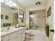 Bathroom featuring a vanity, toilet, and a shower tub combo with gold accents at 3476 Tarpon Woods Blvd, Palm Harbor, FL 34685