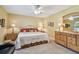 Bedroom featuring two dressers, a ceiling fan, and a large window at 3476 Tarpon Woods Blvd, Palm Harbor, FL 34685