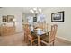 View of the dining room featuring a modern chandelier and glass table at 3476 Tarpon Woods Blvd, Palm Harbor, FL 34685