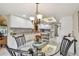 Open-concept dining room view towards the kitchen with bright white cabinetry and modern appliances at 3476 Tarpon Woods Blvd, Palm Harbor, FL 34685