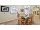 Well decorated dining room with modern chandelier and glass dining room table at 3476 Tarpon Woods Blvd, Palm Harbor, FL 34685