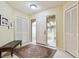 Bright foyer with a white front door, tile floors, and access to storage at 3476 Tarpon Woods Blvd, Palm Harbor, FL 34685