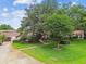 Charming home featuring lush landscaping, mature trees, and a well-maintained front yard at 3476 Tarpon Woods Blvd, Palm Harbor, FL 34685