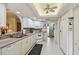 Bright kitchen features white cabinetry, tile floors, and modern appliances at 3476 Tarpon Woods Blvd, Palm Harbor, FL 34685