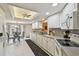 Well-lit kitchen with white cabinetry, tile flooring, and dining area at 3476 Tarpon Woods Blvd, Palm Harbor, FL 34685