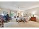 Spacious main bedroom featuring a ceiling fan, a seating area and sliding glass door to the exterior at 3476 Tarpon Woods Blvd, Palm Harbor, FL 34685