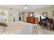 Cozy main bedroom featuring soft carpet, natural wood furniture, and access to the bathroom at 3476 Tarpon Woods Blvd, Palm Harbor, FL 34685