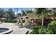 Exterior view of a pool side cabana with shade and lounge chairs nearby at 3476 Tarpon Woods Blvd, Palm Harbor, FL 34685