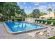 Community pool with plenty of lounge chairs for sunbathing and relaxation at 3476 Tarpon Woods Blvd, Palm Harbor, FL 34685
