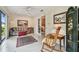 Relaxing sun room featuring tile flooring, a ceiling fan, and a door leading to the bedroom at 3476 Tarpon Woods Blvd, Palm Harbor, FL 34685