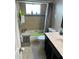 Cozy bathroom featuring a tile-surround bathtub and shower with a window for natural light at 3612 Devonshire Dr, Holiday, FL 34691