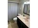 Neutral bathroom featuring a vanity with dark cabinets and a light pink countertop at 3612 Devonshire Dr, Holiday, FL 34691