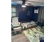 bedroom featuring a toddler bed, rocker, and playmat on wood-look flooring at 3612 Devonshire Dr, Holiday, FL 34691