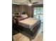 Cozy bedroom with a large bed, wood-style floors, and access to an outdoor patio for relaxation and enjoyment at 3612 Devonshire Dr, Holiday, FL 34691