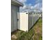 Exterior featuring a white vinyl fence and yard at 3612 Devonshire Dr, Holiday, FL 34691
