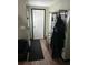 Hallway with wood floors and neutral-colored walls, providing a clean and functional transition between rooms at 3612 Devonshire Dr, Holiday, FL 34691